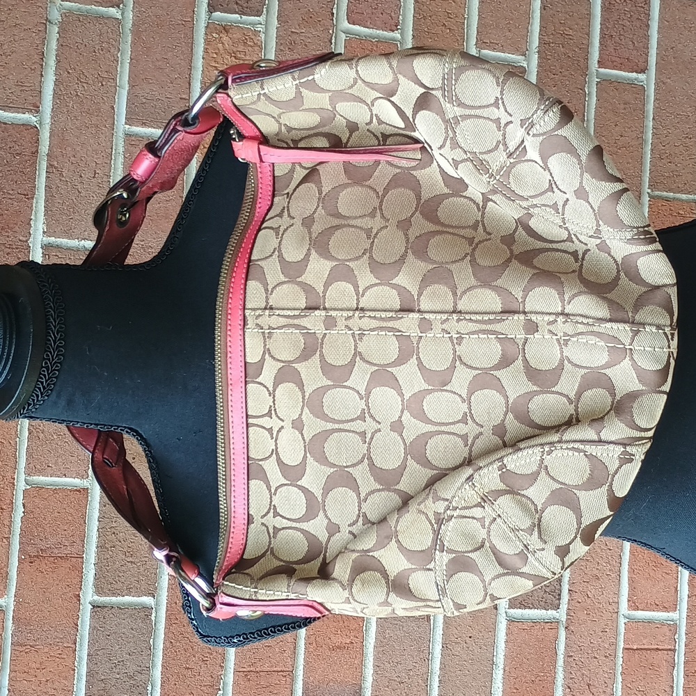 Coach bag with hot pink trim. Braided strap with buckles